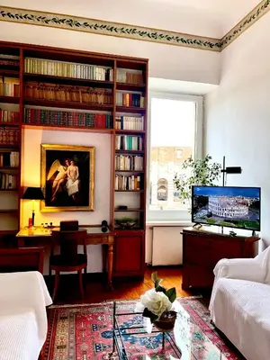 a living room with a couch and a table and a tv at Colosseum Luxury Apartment in Rome