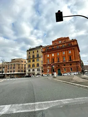 an intersection with a red traffic light and buildings at Colosseum Luxury Apartment in Rome