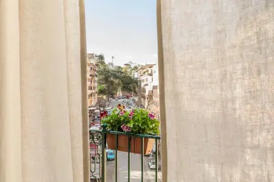 a balcony of a building with flowers on it at Elegante Dimora a Trastevere in Rome