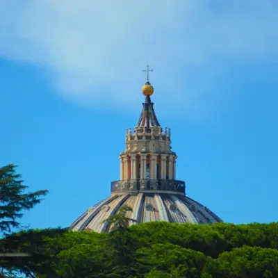 a steeple of a building with a cross on it at San Peter Terrace View in Rome