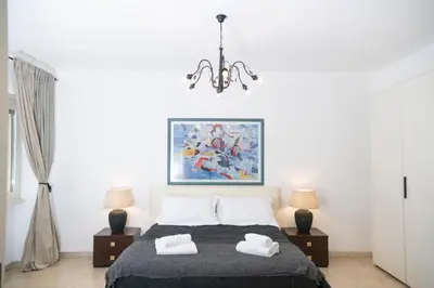 a bedroom with a bed and a chandelier at San Peter Terrace View in Rome