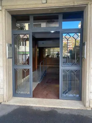 an entrance to a building with glass doors at San Peter Terrace View in Rome