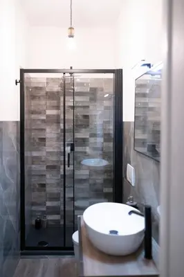 a bathroom with a shower with a sink and a toilet at San Peter Terrace View in Rome