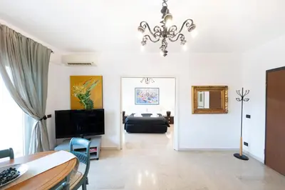 a living room with a chandelier and a couch at San Peter Terrace View in Rome