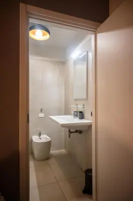 a bathroom with a white sink and a mirror at Gate 40 Roma in Rome