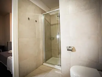 a shower with a glass door in a bathroom at Gate 40 Roma in Rome