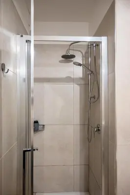 a shower with a glass door in a bathroom at Gate 40 Roma in Rome
