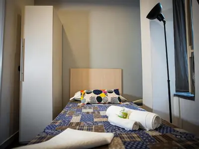 a bedroom with a bed with two towels on it at Gate 40 Roma in Rome