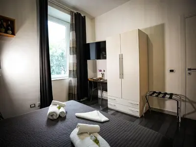 a bedroom with a bed with towels on it at Gate 40 Roma in Rome