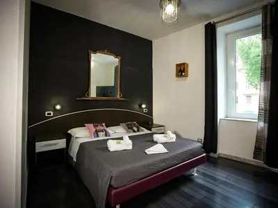 a bedroom with a bed with a mirror on the wall at Gate 40 Roma in Rome