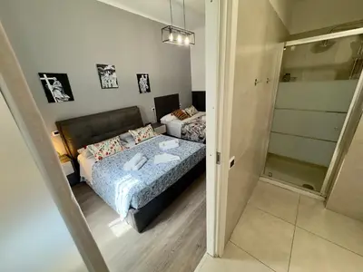 a bedroom with a bed and a walk in closet at Gate 40 Roma in Rome