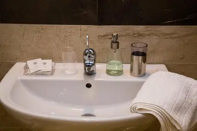 a bathroom sink with a soap dispenser on it at Trastevere's Friends in Rome