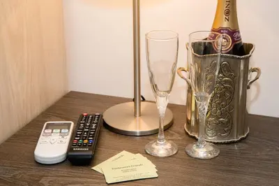 a table with a bottle of champagne and two glasses at Trastevere's Friends in Rome