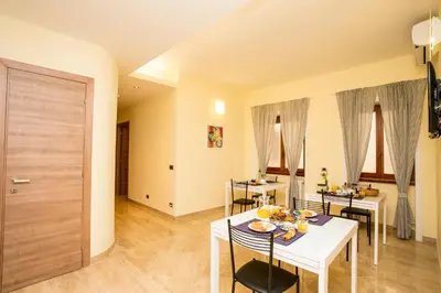 a dining room with a white table and chairs at Trastevere's Friends in Rome