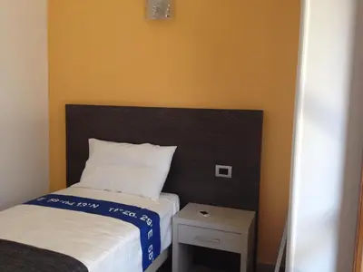 a small bedroom with a bed and a night stand at Trastevere's Friends in Rome