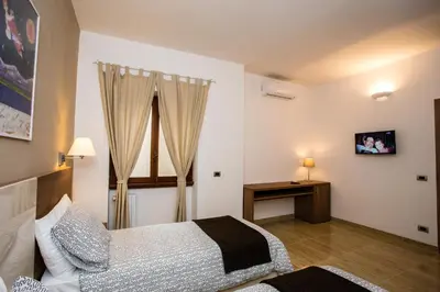 a bedroom with a bed and a table and a window at Trastevere's Friends in Rome