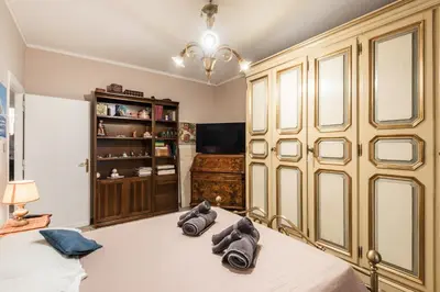 a bedroom with a bed with two pairs of shoes at Appartamento Roma Centro in Rome