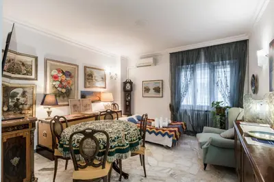 a living room with a table and chairs at Appartamento Roma Centro in Rome