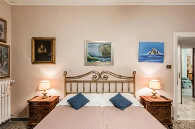 a bedroom with a large bed with two night stands at Appartamento Roma Centro in Rome