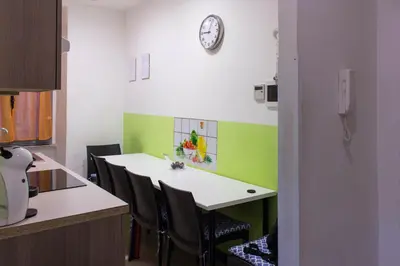 a room with a table and chairs and a clock on the wall at Lucky Domus Ottaviano in Rome
