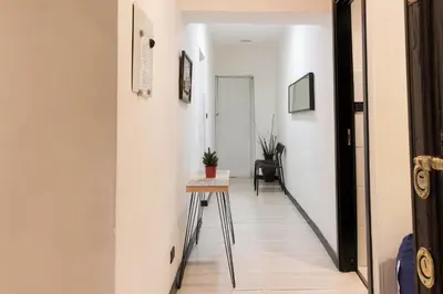a hallway with a table in the middle of a room at Lucky Domus Ottaviano in Rome