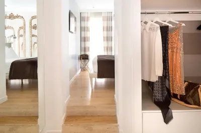 a room with a closet with clothes at Via Del Corso Home Roma in Rome