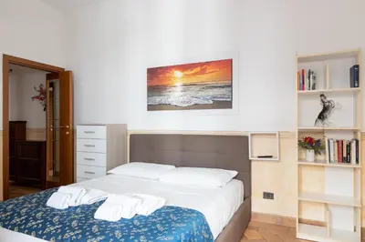 a bedroom with a bed with two white towels on it at Elegant & Quiet Apartment next to Colosseo in Rome
