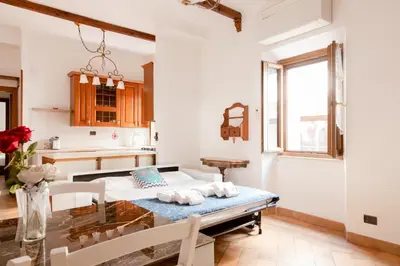 a kitchen with a table and a dining room at Elegant & Quiet Apartment next to Colosseo in Rome
