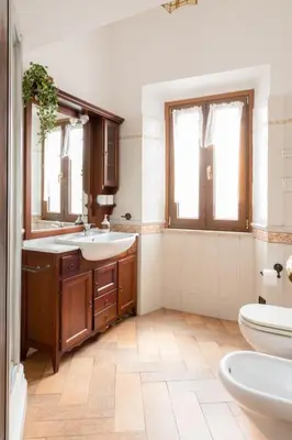a bathroom with two sinks and a toilet at Elegant & Quiet Apartment next to Colosseo in Rome
