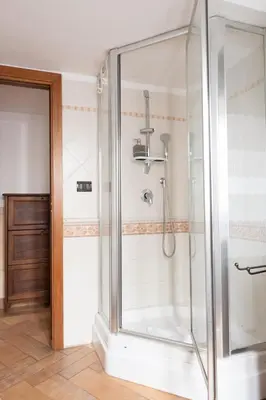 a shower with a glass door in a bathroom at Elegant & Quiet Apartment next to Colosseo in Rome