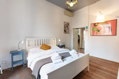 a bedroom with a large white bed with towels on it at La Locanda Bertani in Rome