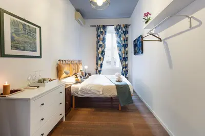 a small bedroom with a bed and a desk at La Locanda Bertani in Rome