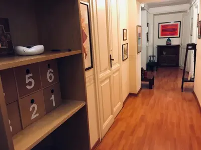 a room with a hallway with a wooden floor at A Place in Prati in Rome