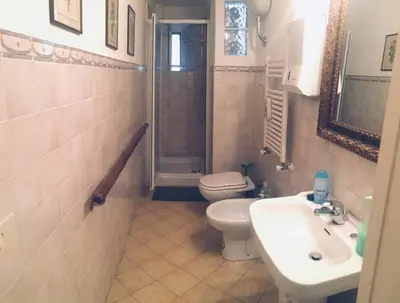 a bathroom with a toilet and a sink and a shower at A Place in Prati in Rome