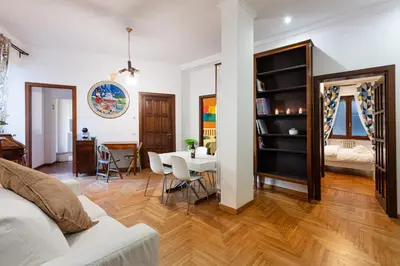 a living room with a white couch and a table at Passeggiata al Vaticano in Rome
