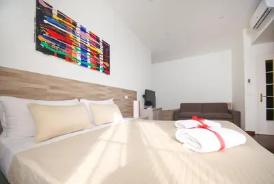 a bedroom with a bed with two towels on it at Rome Aparts - Deluxe Apartment with 3 bedrooms at St Peter square in Rome