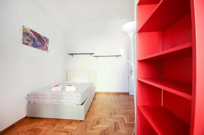 a bedroom with a bed and red shelves at Rome Aparts - Deluxe Apartment with 3 bedrooms at St Peter square in Rome