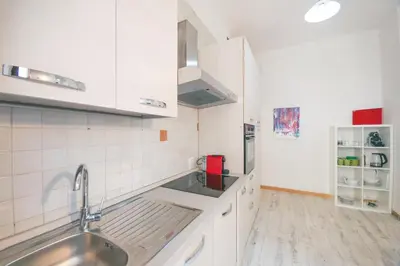 a kitchen with white cabinets and a sink at Rome Aparts - Deluxe Apartment with 3 bedrooms at St Peter square in Rome