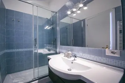 a bathroom with a sink and a mirror at Rome Aparts - Deluxe Apartment with 3 bedrooms at St Peter square in Rome