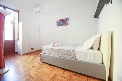 a bedroom with a bed and a wooden floor at Rome Aparts - Deluxe Apartment with 3 bedrooms at St Peter square in Rome