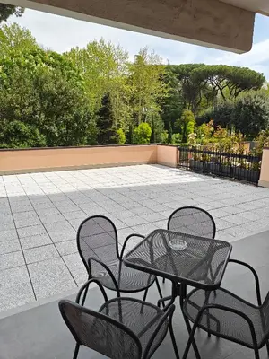 a patio with two chairs and a table and a table and chairs at Appartamento Aurelio - Vaticano in Rome