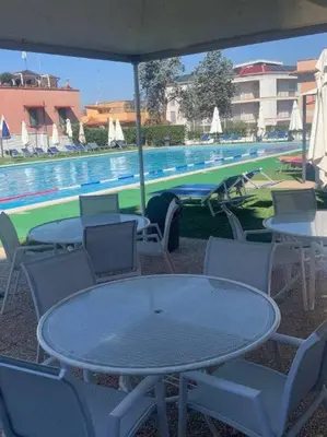 a table and chairs next to a swimming pool at Appartamento Aurelio - Vaticano in Rome