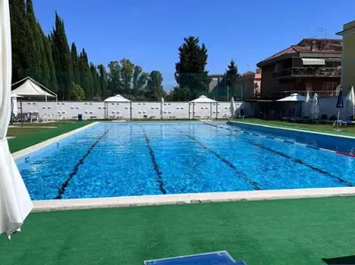 a large swimming pool with blue water at Appartamento Aurelio - Vaticano in Rome