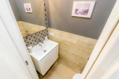 a bathroom with a white sink and a mirror at Contessa Elegance Inn in Rome