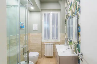 a bathroom with a toilet and a sink and a shower at Contessa Elegance Inn in Rome