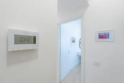 a sliding door with a gift sign on a wall at Contessa Elegance Inn in Rome