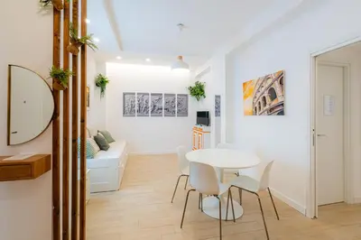 a white dining room with a table and chairs at Contessa Elegance Inn in Rome