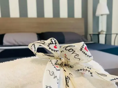 a white mask sitting on top of a bed at PortamiPortese Trastevere Terrace in Trastevere