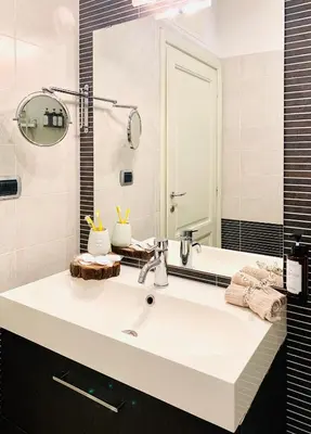a bathroom with a white sink and a mirror at PortamiPortese Trastevere Terrace in Trastevere
