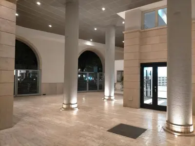 a lobby with columns and a door in a building at PortamiPortese Trastevere Terrace in Trastevere